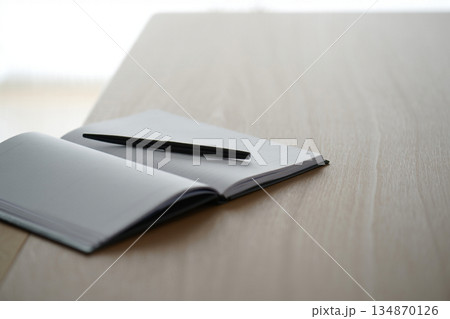 notebook and pen on table 134870126