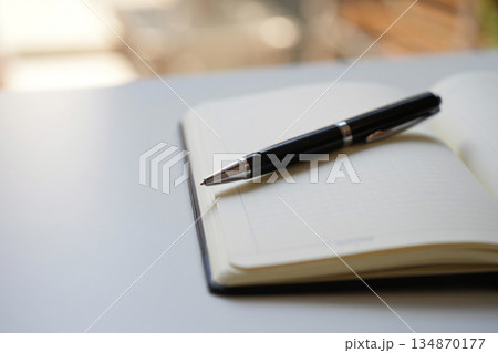 notebook and pen on office desk 134870177