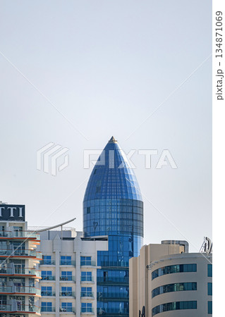 Blue glass skyscraper building with distinctive pointed top, architecture Blue glass skyscraper building with distinctive pointed top, architecture 134871069