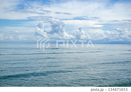 Open ocean surface with scattered cloud puffs and subtle wave texture under bright daylight, Kuala Penyu, Sabah, Malaysia. Open ocean surface with scattered cloud puffs and subtle wave texture under bright daylight, Kuala Penyu, Sabah, Malaysia. 134871653
