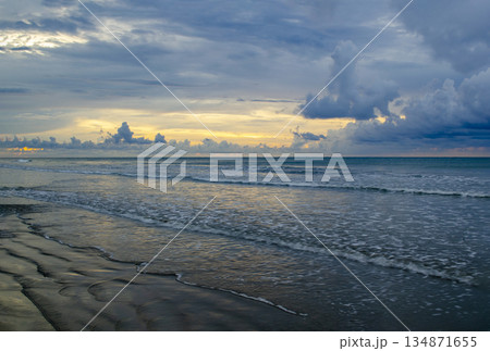 Late-day ocean view with golden horizon band, layered clouds, and gentle wave patterns, Kuala Penyu, Sabah, Malaysia. Late-day ocean view with golden horizon band, layered clouds, and gentle wave patterns, Kuala Penyu, Sabah, Malaysia. 134871655