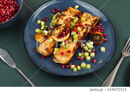 Two grilled salmon steaks on a wooden table. 134872525