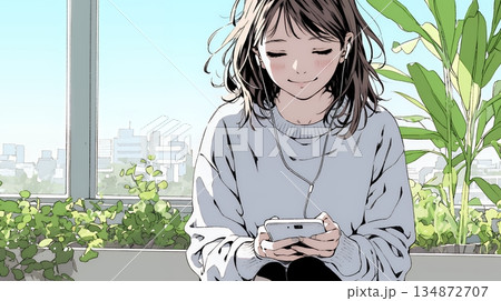 楽しそうにスマホ画面を眺めている若い女性