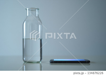 blue water in glass on grey background 134876226