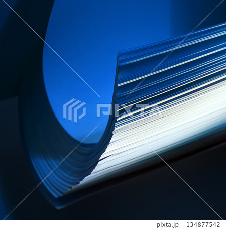 Curved pages of book in darkness 134877542