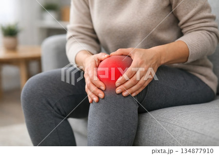 Woman Holding Painful Knee with Red Highlight Showing Joint Inflammation Woman Holding Painful Knee with Red Highlight Showing Joint Inflammation 134877910