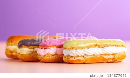 Row of Colorful Cream-Filled Eclairs on Pastel Background, Dessert Display 134877951
