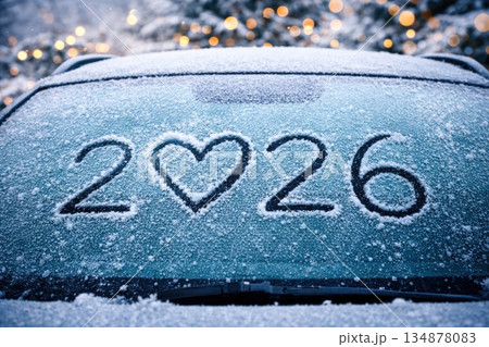 Frozen Car Windshield with 2026 and Heart Symbol Written on Snowy Glass in Winter 134878083
