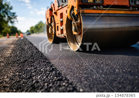 Road Construction Roller Compacting Fresh Asphalt Surface 134878365