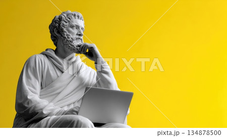 Classical Thinker Statue Using Laptop on Yellow Background Classical Thinker Statue Using Laptop on Yellow Background 134878500