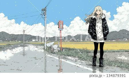 雪解けでぬかるんだ道を歩く若い女性