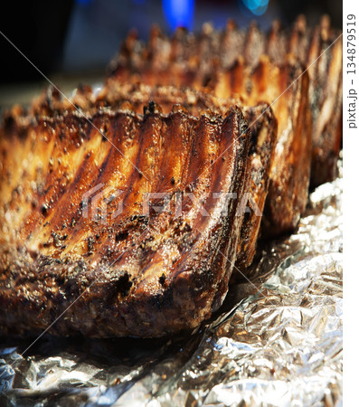 Fried ribs lie on foil 134879519
