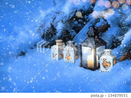 Lanterns in the snow under the Christmas tree Lanterns in the snow under the Christmas tree 134879551