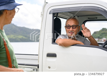 軽トラックの男性が手を振る 【撮影協力：隠岐シーサイドリゾートみやび様】 134879927