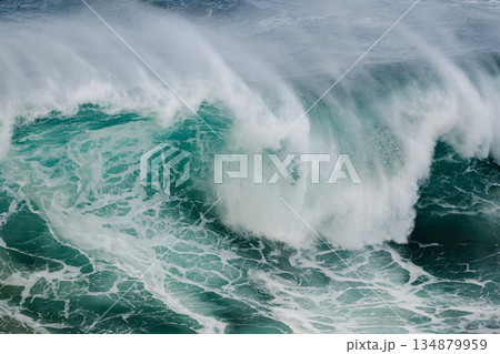 Majestic crashing ocean wave curling with turquoise water and white spray 134879959