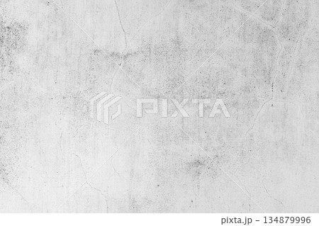 A neutral gray concrete wall texture featuring faint cracks 134879996