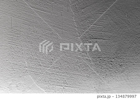 A neutral gray wall with a rich, rough texture and soft gradient A neutral gray wall with a rich, rough texture and soft gradient 134879997