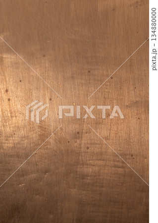 A close-up of a copper toned brushed metal sheet, background texture 134880000