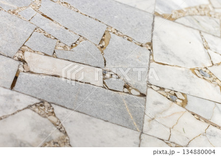 A close-up view of a flooring built from large flat stones, background texture A close-up view of a flooring built from large flat stones, background texture 134880004