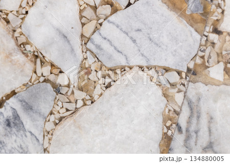 Top view of a flooring built from large flat stones separated by small pebbles Top view of a flooring built from large flat stones separated by small pebbles 134880005