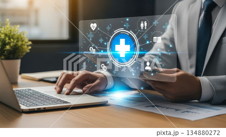 Health insurance digital concept with medical cross icons on tablet and laptop in modern office 134880272