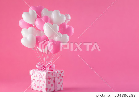 Pink heart balloons floating from gift box on pastel background for love romance valentine celebration concept 134880288