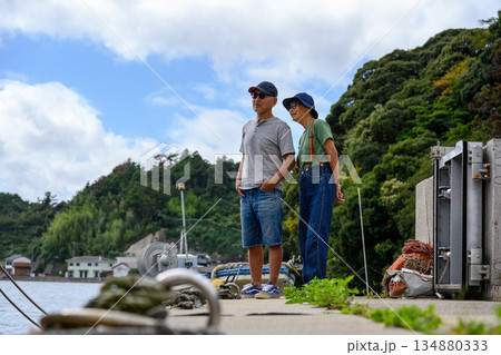 桟橋で海を眺める夫婦 【撮影協力：隠岐シーサイドリゾートみやび様】 134880333
