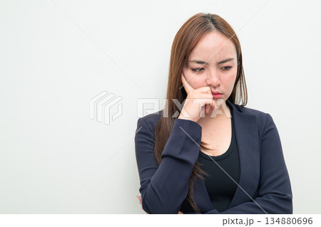Portrait of a young Asian businesswoman against white background Portrait of a young Asian businesswoman against white background 134880696