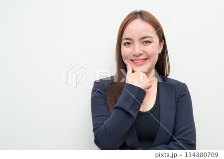 Portrait of a young happy Asian businesswoman against white background thinking Portrait of a young happy Asian businesswoman against white background thinking 134880709