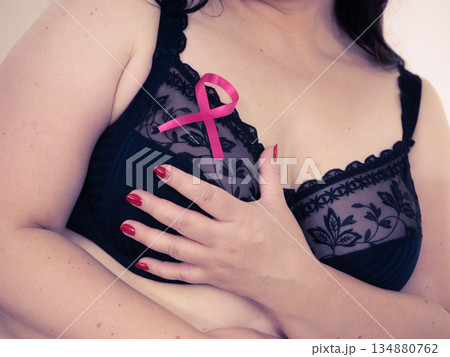 Woman chest in bra, pink cancer ribbon 134880762