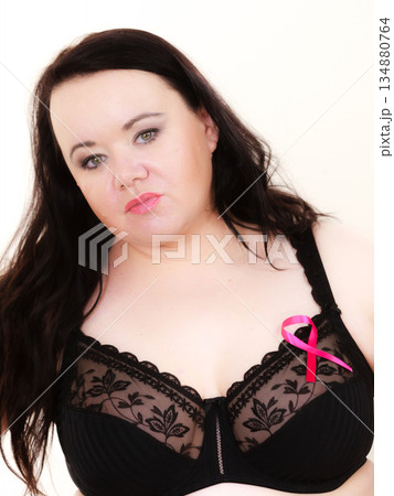 Big woman in bra with pink cancer ribbon 134880764