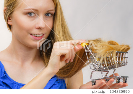 Girl with her long hair in shopping cart Girl with her long hair in shopping cart 134880990
