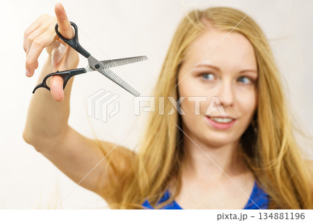 Girl with scissors thinning shears Girl with scissors thinning shears 134881196