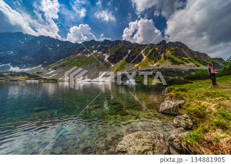 Crystal clear alpine lake with mountain reflections in High Tatras 134881905