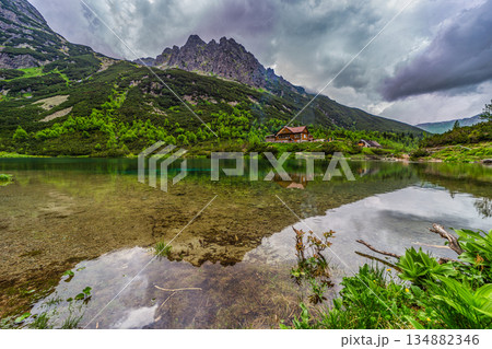 Dark storm clouds over alpine lake Zelene pleso in High Tatras Dark storm clouds over alpine lake Zelene pleso in High Tatras 134882346