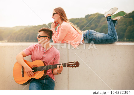 Happy couple with guitar outdoor Happy couple with guitar outdoor 134882394