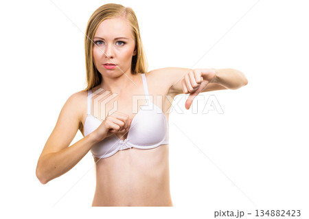 Woman dissatisfied with size of bra breasts 134882423