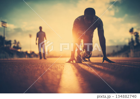 Disabled athlete training on track at sunset with strong support and determination, preparing for race with prosthetic leg and focused mindset 134882740