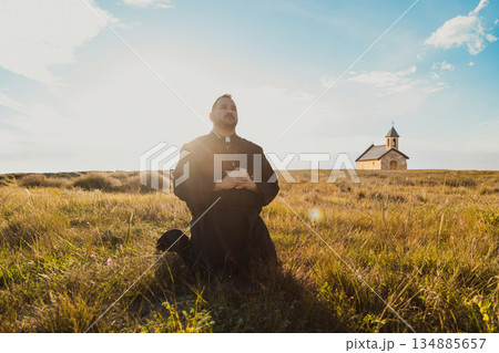 Catholic Monk Praying Under The Sun Of God Catholic Monk Praying Under The Sun Of God 134885657