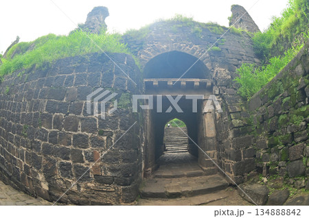 Classic arched entrance at Daulatabad Fort is an ancient fort located in Maharashtra, India. Originally named Deogiri, it is a fort built from natural rocks and is very strong. Classic arched entrance at Daulatabad Fort is an ancient fort located in Maharashtra, India. Originally named Deogiri, it is a fort built from natural rocks and is very strong. 134888842