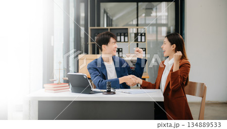 Asian business team and lawyers discussing contract papers sitting at the table. Concepts of law, advice, legal services. at office 134889533