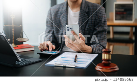 Women counting coins on calculator taking from the piggy bank. hand holding pen working on calculator to calculate on desk about cost at home office. Women counting coins on calculator taking from the piggy bank. hand holding pen working on calculator to calculate on desk about cost at home office. 134889568