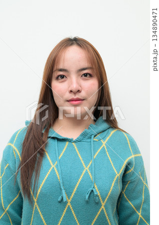 Portrait of a young Asian woman against white background Portrait of a young Asian woman against white background 134890471