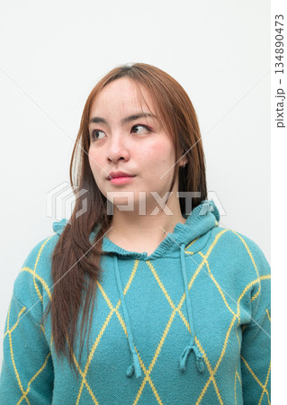 Portrait of a young Asian woman against white background Portrait of a young Asian woman against white background 134890473