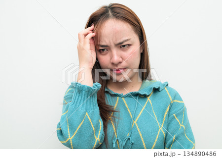 Portrait of a young stressed Asian woman against white background thinking Portrait of a young stressed Asian woman against white background thinking 134890486