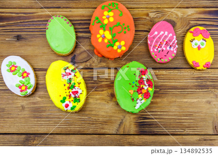Egg shaped easter gingerbread cookies on wooden table. Top view. Sweets for celebrate Easter Egg shaped easter gingerbread cookies on wooden table. Top view. Sweets for celebrate Easter 134892535