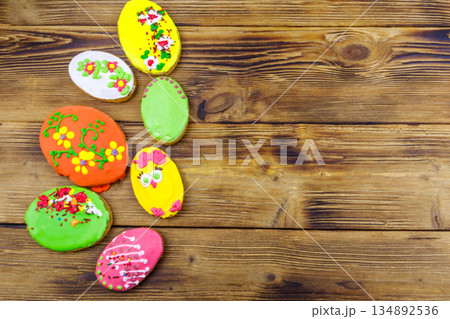 Egg shaped easter gingerbread cookies on wooden table. Top view, copy space. Sweets for celebrate Easter Egg shaped easter gingerbread cookies on wooden table. Top view, copy space. Sweets for celebrate Easter 134892536