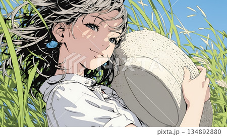 春風に飛ばされそうな帽子を、手で押さえる若い女性