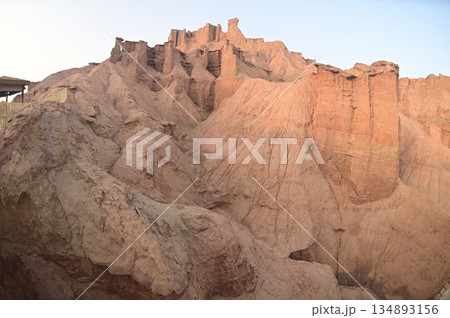 Kizil Red Stone Forest Scenic Area in Xinjiang , China is the strangely shaped red rock forests were carved by wind and sand over millions of years, giving them the appearance of abandoned cities. 134893156