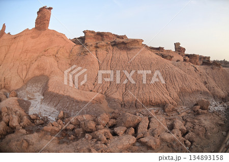 Kizil Red Stone Forest Scenic Area in Xinjiang , China is the strangely shaped red rock forests were carved by wind and sand over millions of years, giving them the appearance of abandoned cities. 134893158